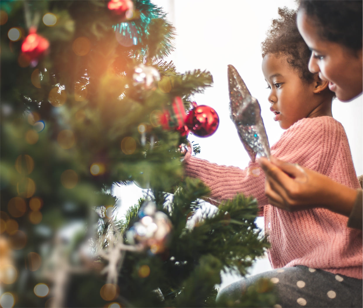 small kid decorating the christmas tree